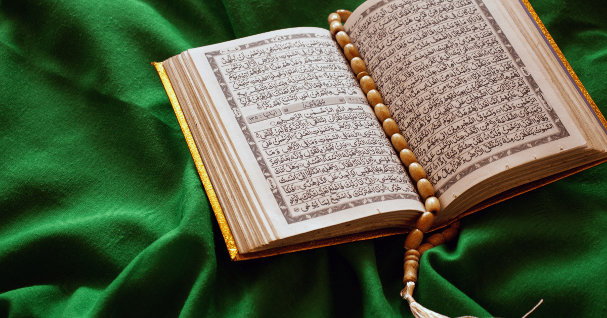 A photo of the Quran on a green textile