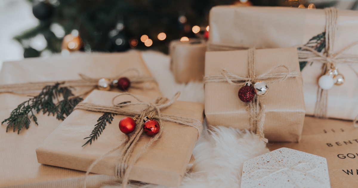 A photo of wrapped presents underneath a christmas tree