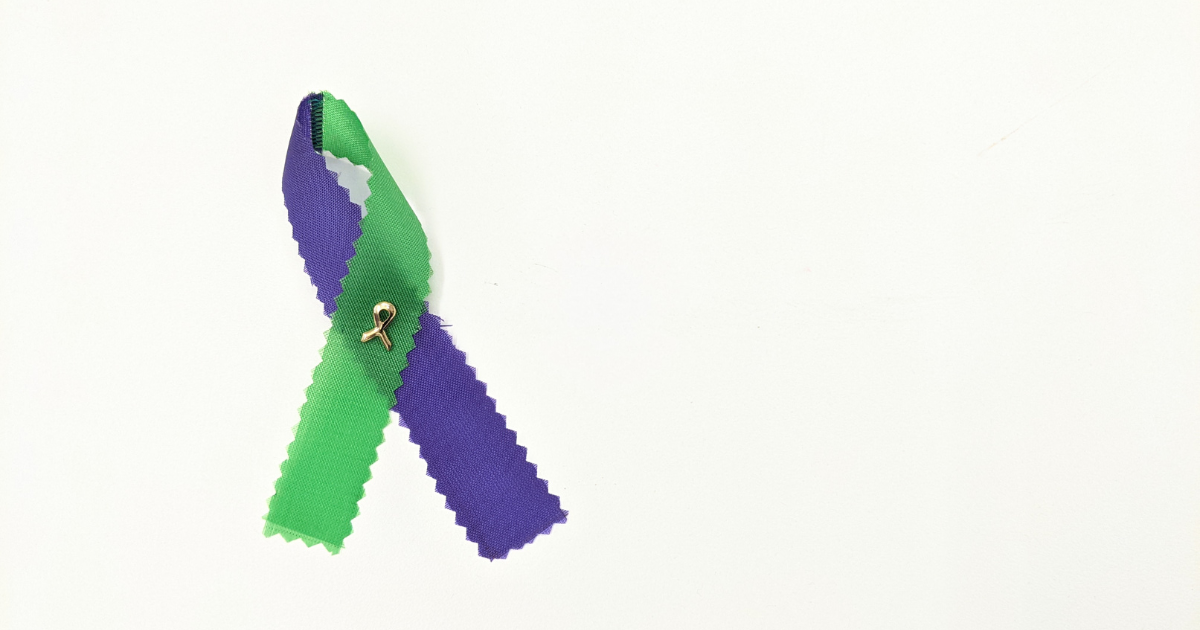 : A purple and green ribbon on a white background