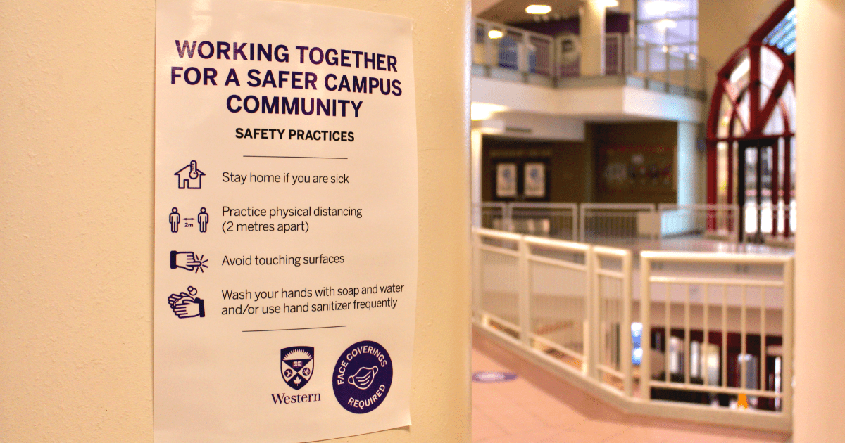 An image of a sign on campus informing people of COVID-19 rules