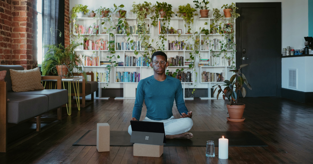 a man sitting on the floor of a room meditating