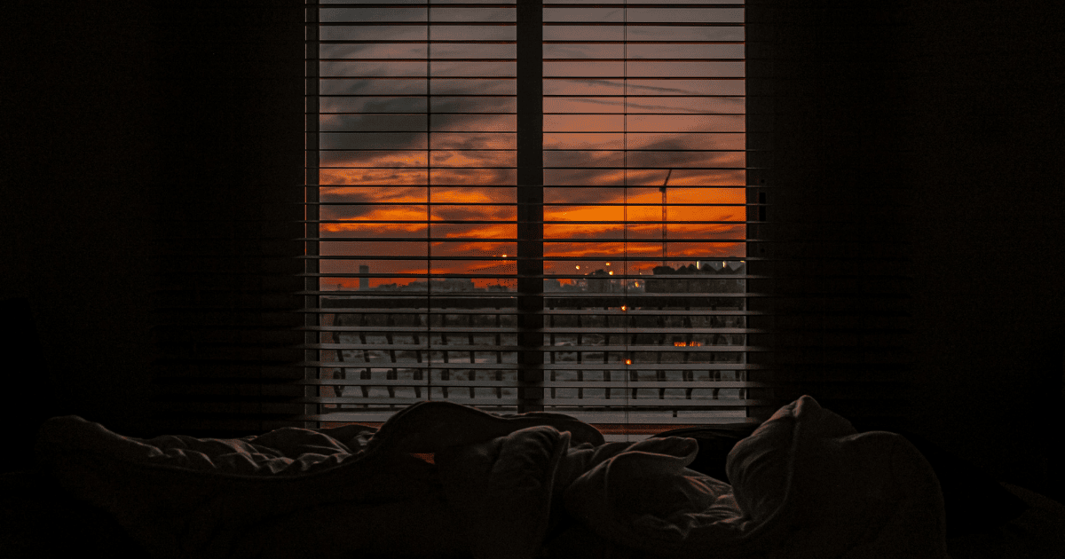 The view from the end of someone's bed looking out into the night sky