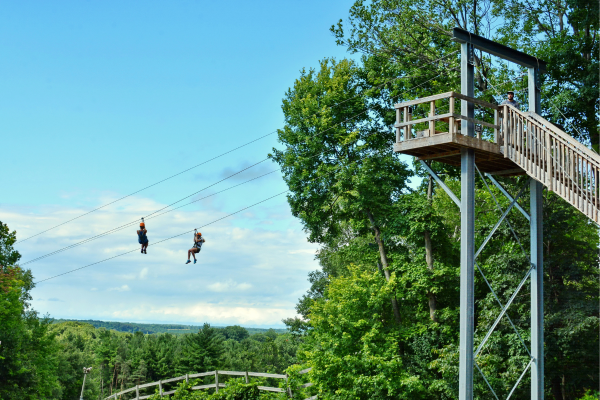 Two people ziplining at Boler Mountain.