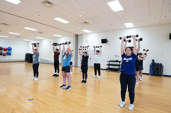 A group of students working out during a fitness class.