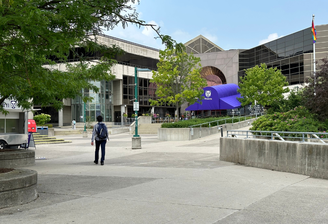 A Student Walking Towards the UCC on Campus.