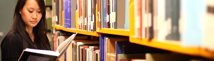 Girl in Library looking at a book