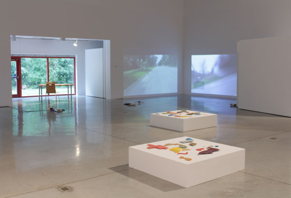 installation view, video projections and sculptures