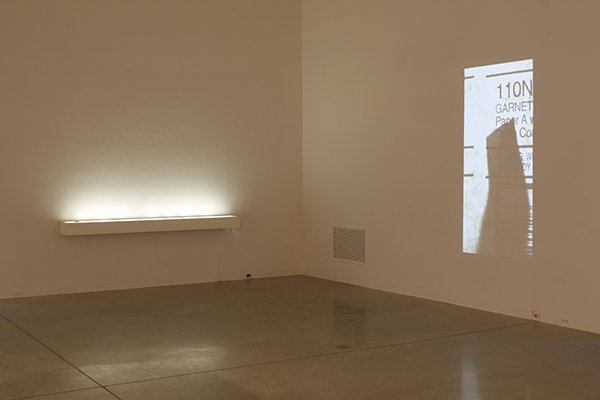 installation view, lightbox and video projection on wall