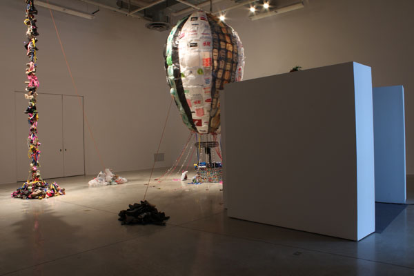 installation view (shoes hung from ceiling, balloon made of shopping bags)