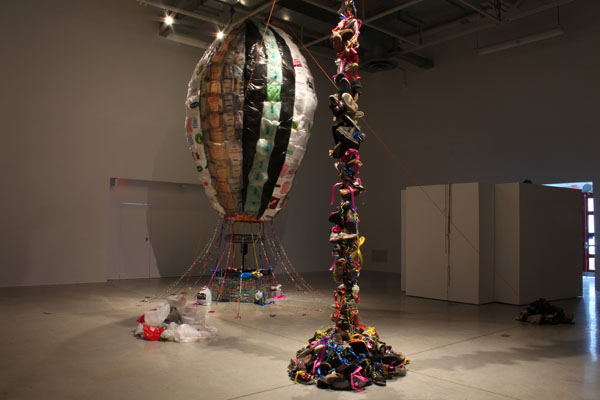 installation view (shoes hung from ceiling and shopping bag balloon)