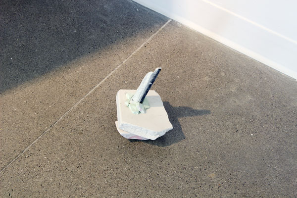installation view, small plaster sculpture on floor