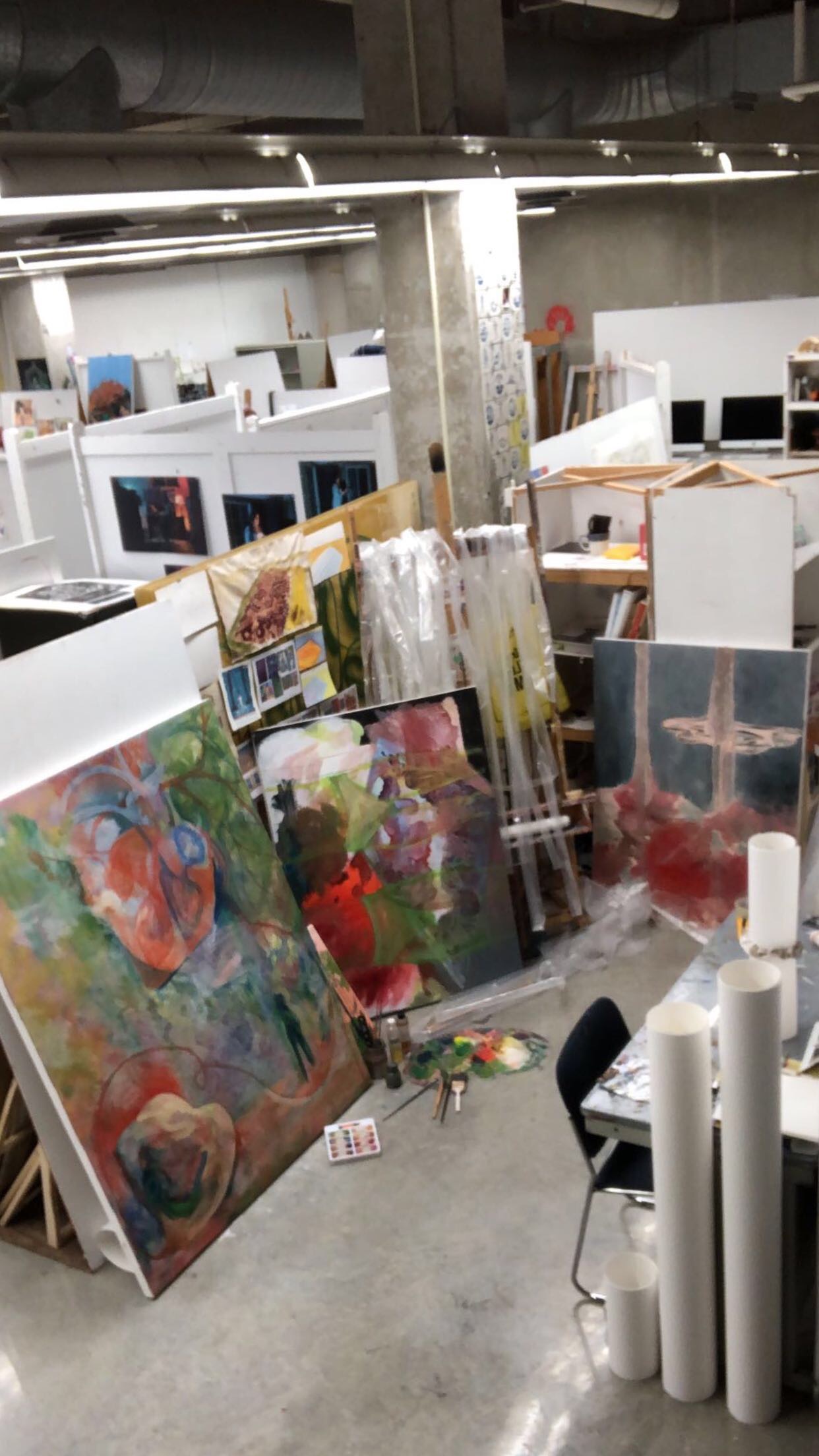 Overhead photo of a studio space containing canvases being worked on.