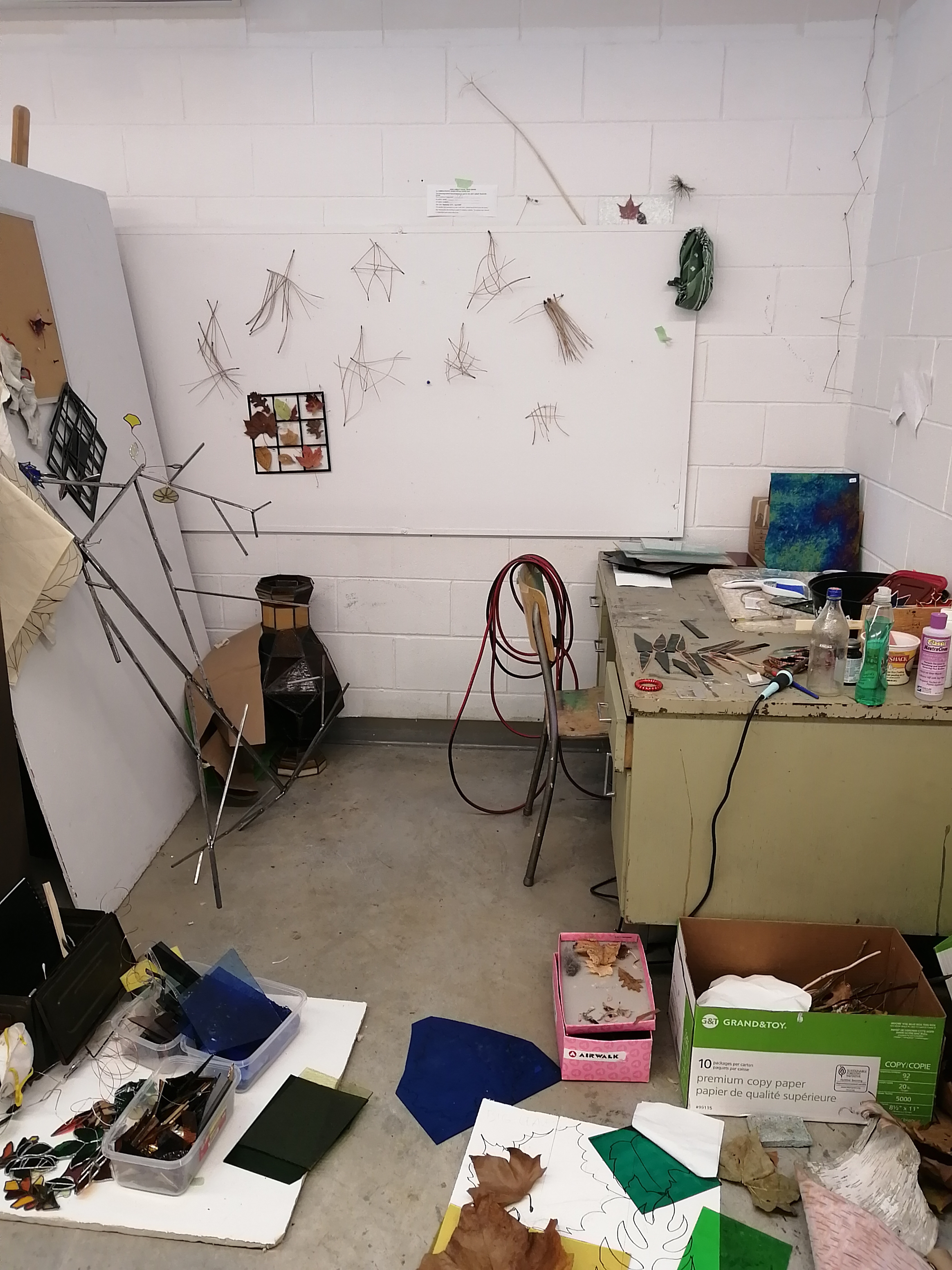 Photo of a studio space with boxes and pieces of glass organized neatly.