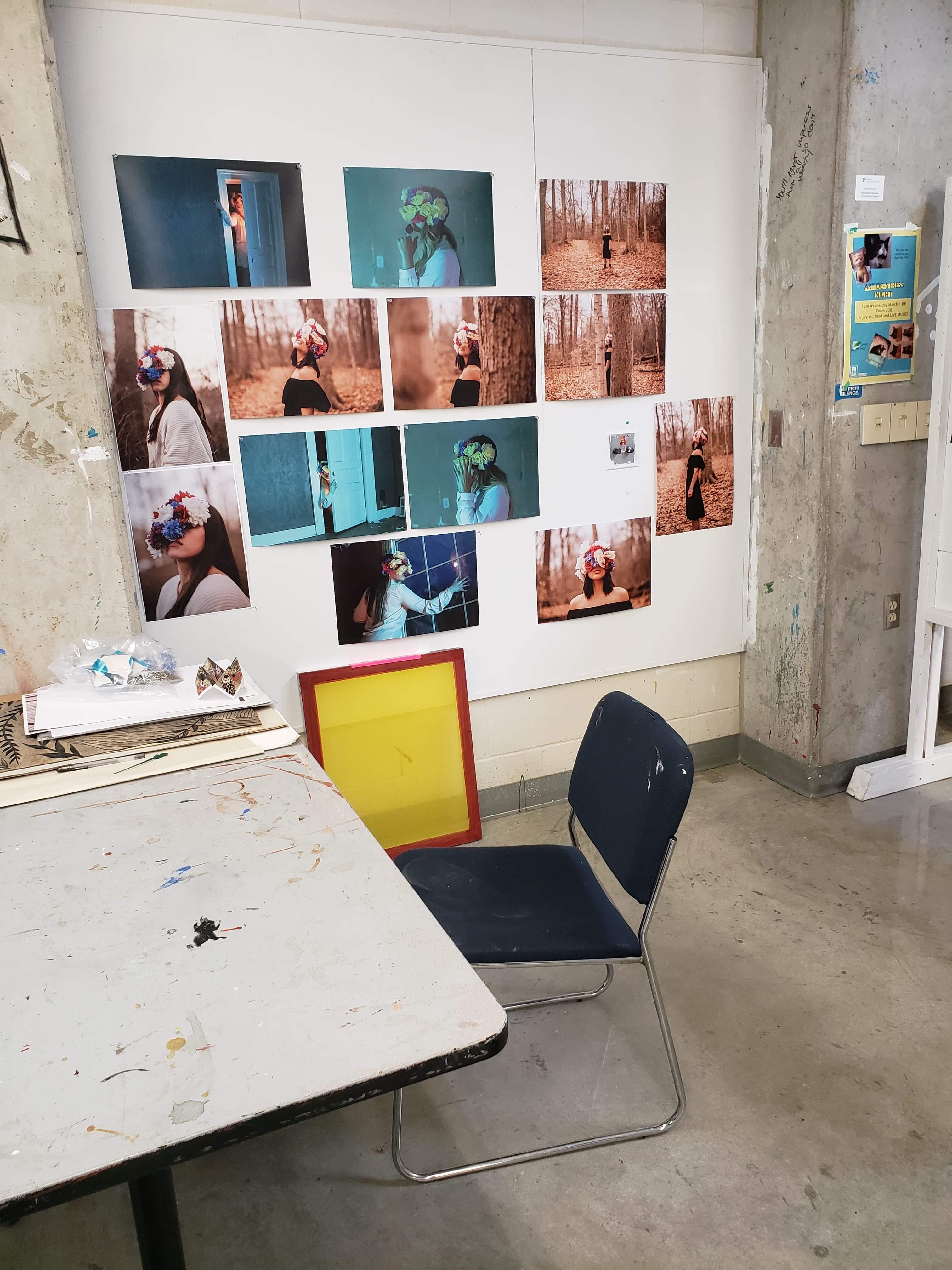 Photo of a studio with photo prints pinned to a board for review.